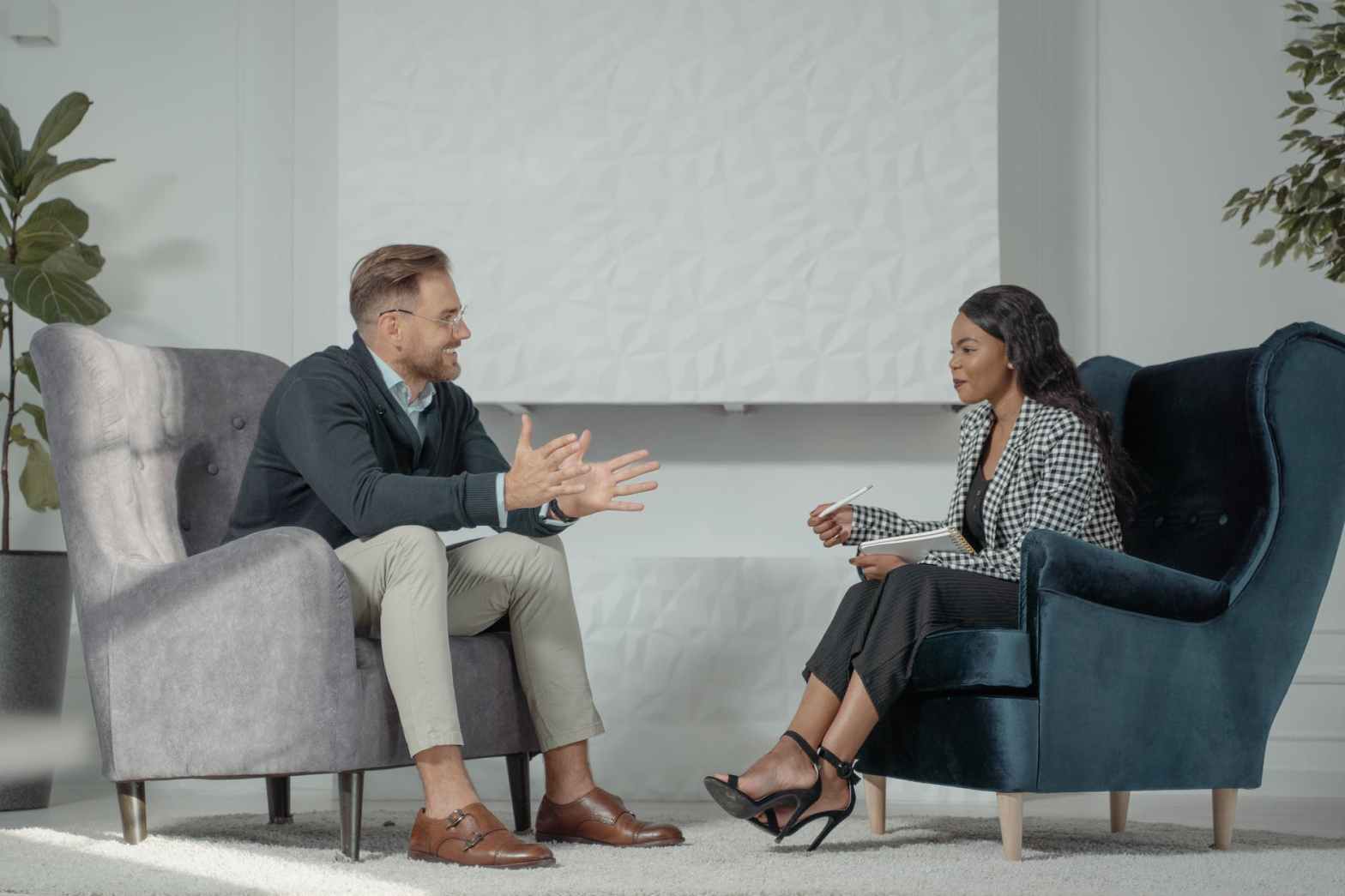 a woman interviewing a man